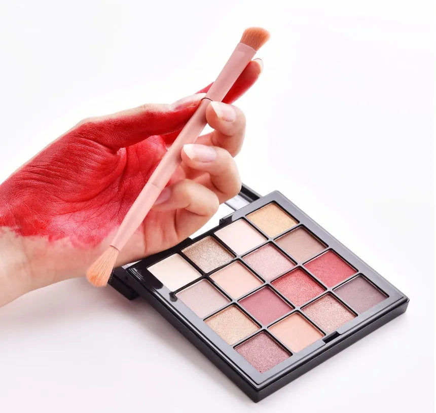 Ten professional makeup brushes with wooden handles arranged in a set, including powder, foundation and detail brushes