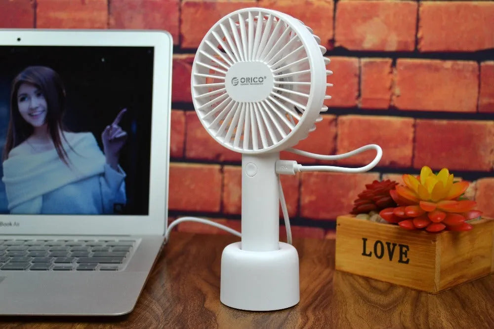 White ORICO FH1 portable USB rechargeable desk fan showing three-speed buttons and compact design