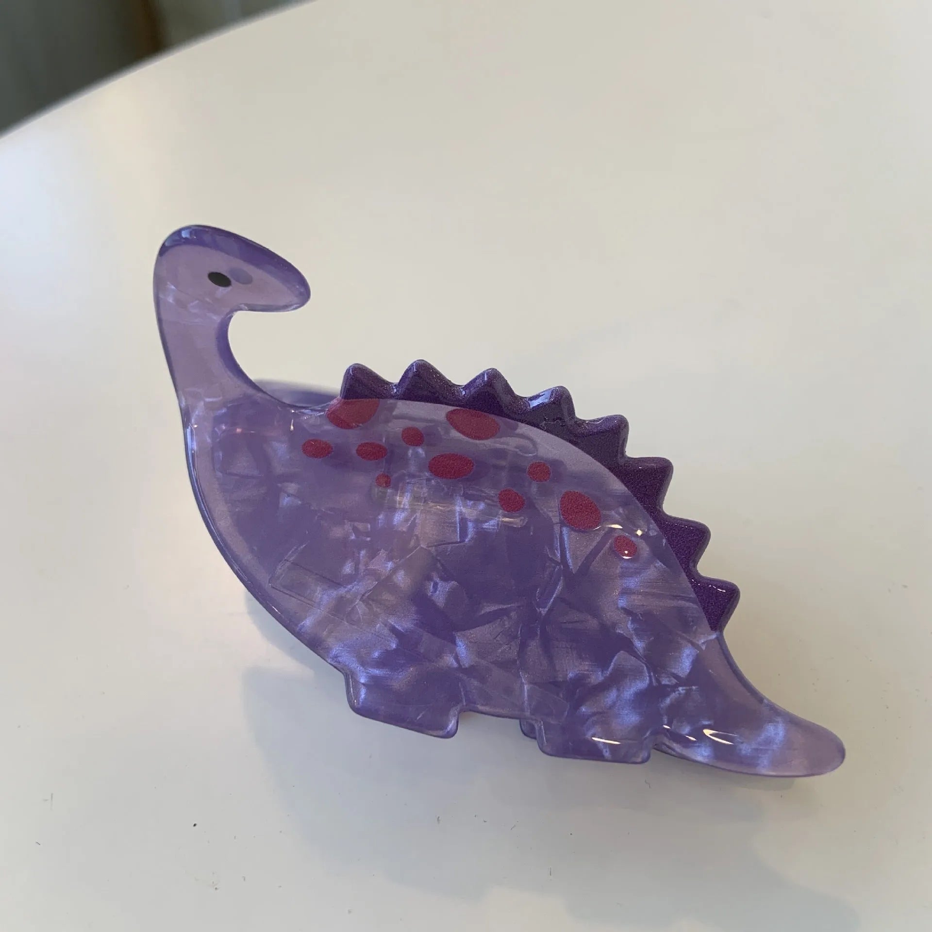 Dinosaur acrylic jaw hair clip showing grip mechanism and detailed dinosaur design in available colour options