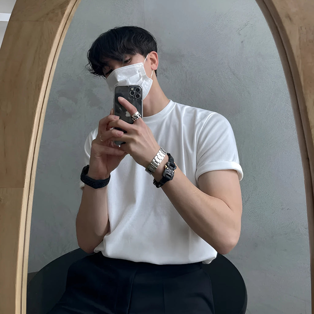 Men's slim-fit cotton T-shirt in solid white colour with half-length sleeves on a hanger.
