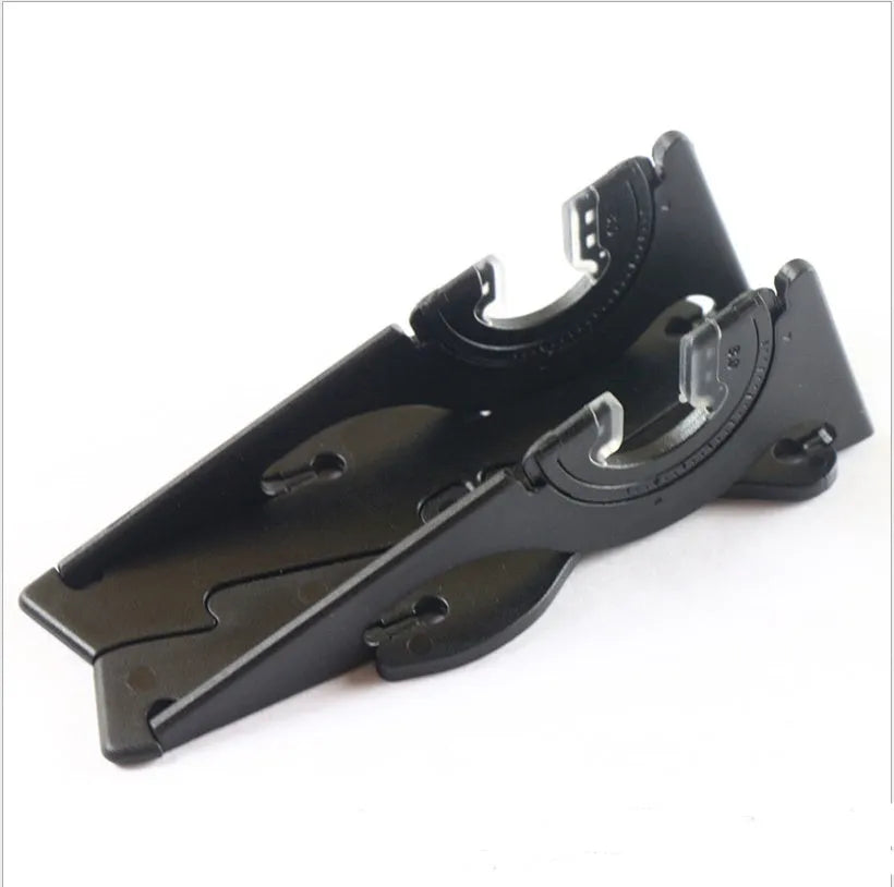 Black plastic card type mobile phone holder for desktop use on a wooden desk