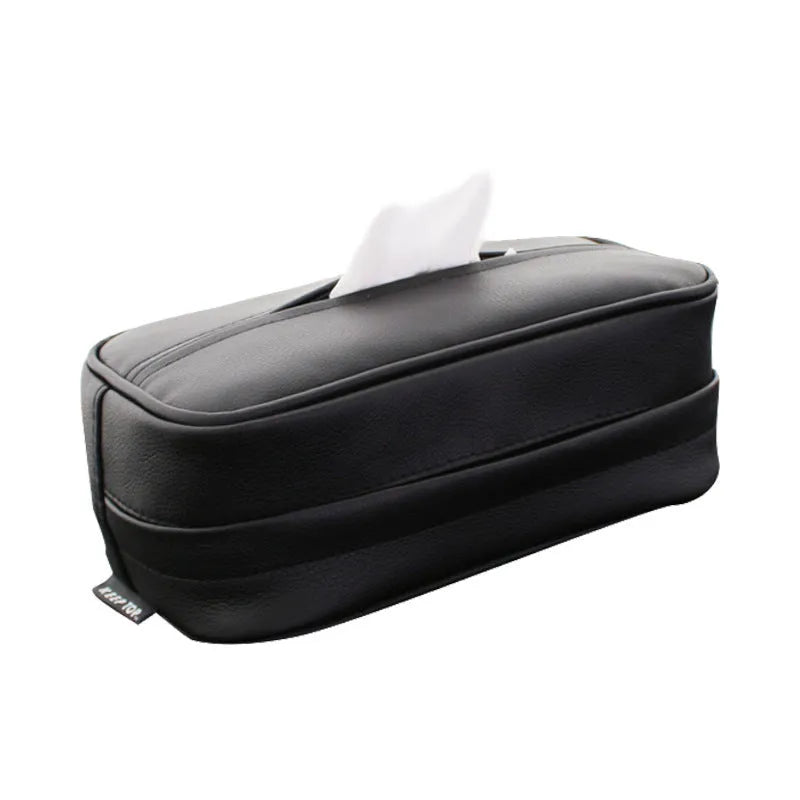 Black leather storage box with removable paper bag inside for car and home organisation.