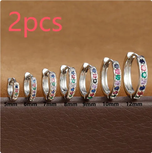 Perforated circle zircon stud earrings in gold, rose gold, or silver colour on white background