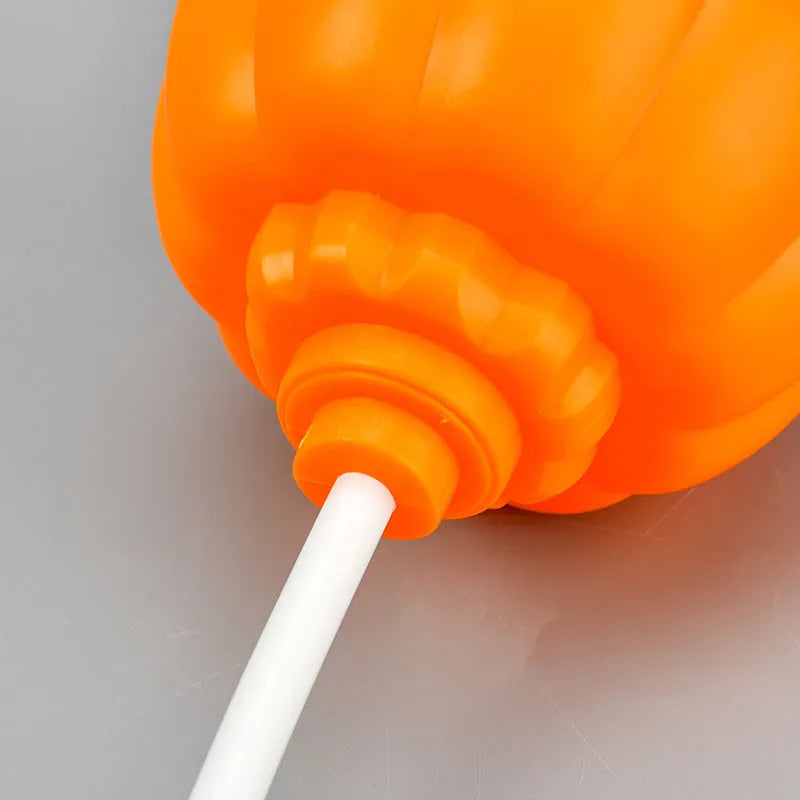 Plastic pumpkin lamp with USB port showing yellow and purple light options