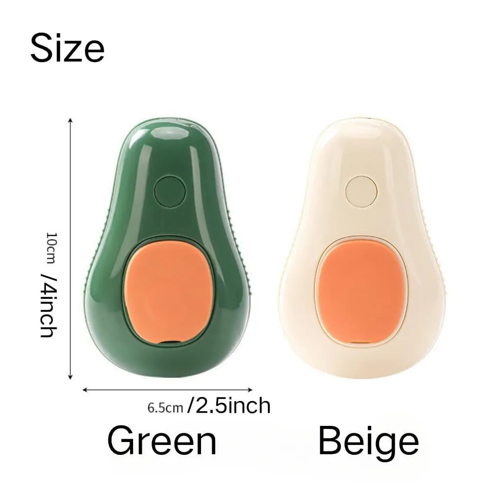 Green and white rechargeable cat steam brush with soft silicone teeth on a wooden table