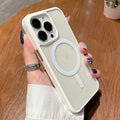 Transparent acrylic MagSafe phone case for iPhone on a table, showing magnetic ring and clear back.