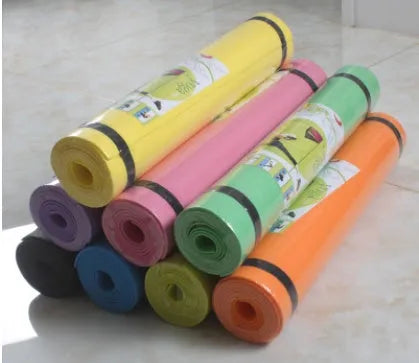 EVA fitness yoga mat in blue, showing its texture and thickness, rolled up with its OPP storage bag.