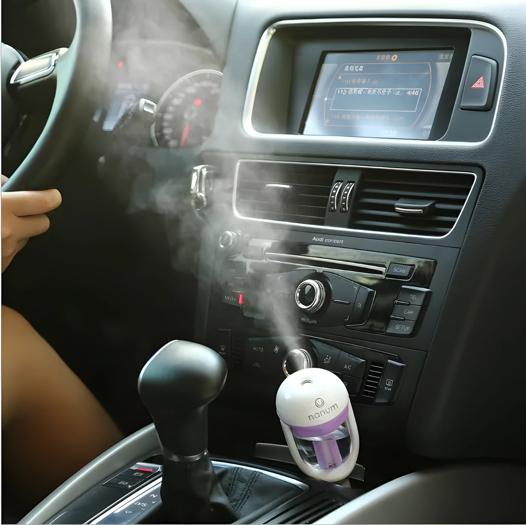 Blue portable car humidifier air purifier with 180 degree rotation on car dashboard