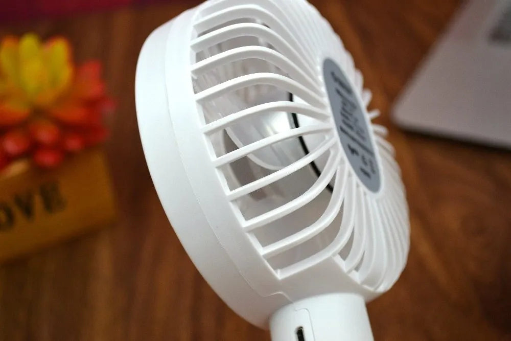White ORICO FH1 portable USB rechargeable desk fan showing three-speed buttons and compact design