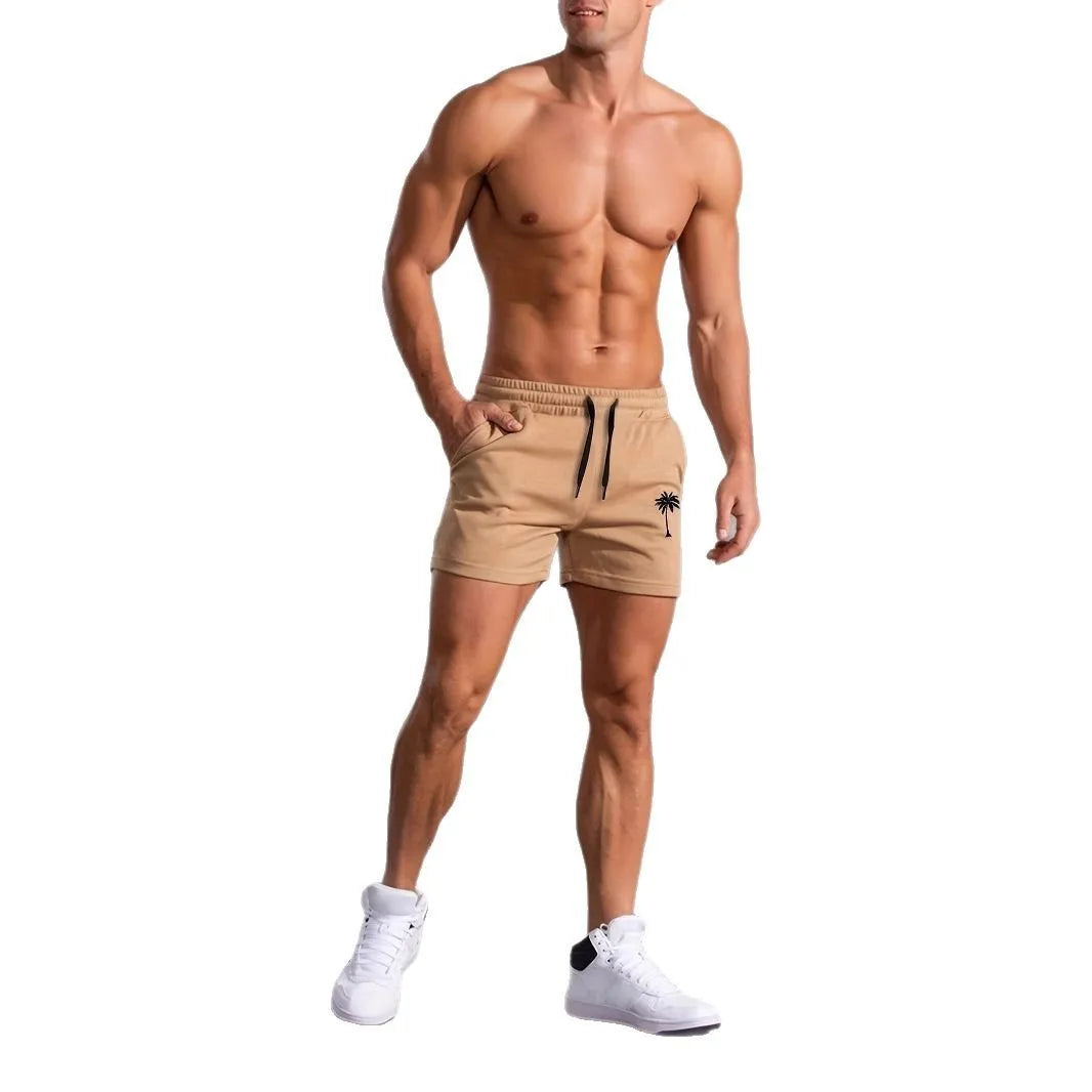 Khaki men's sports shorts with a white coconut leaf print, showing straight leg fit.