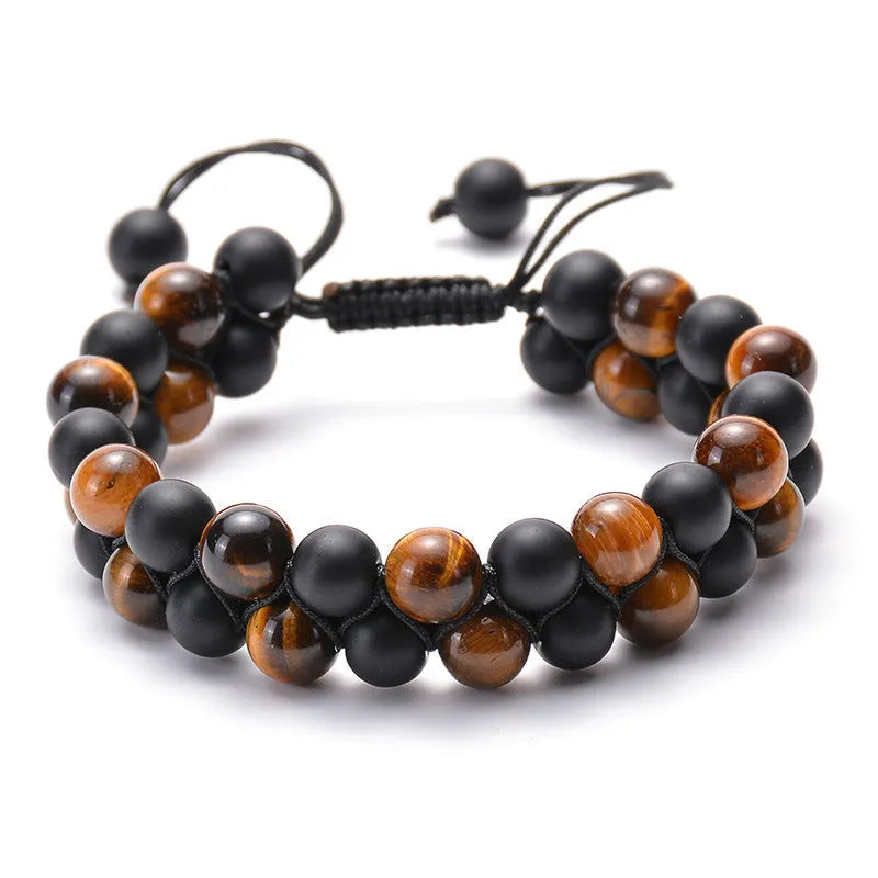 Matte black agate tiger eye bead couple bracelets with geometric design on a neutral background.