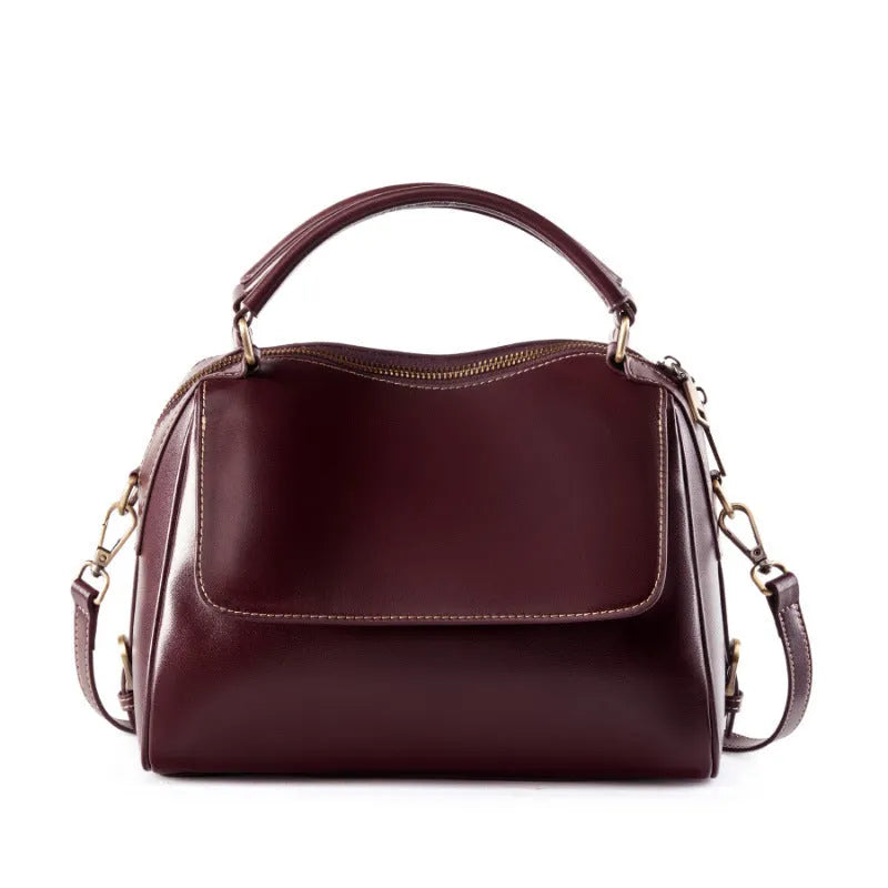 Women's genuine leather crossbody tote bag in apricot colour with double straps and outer slit pocket.