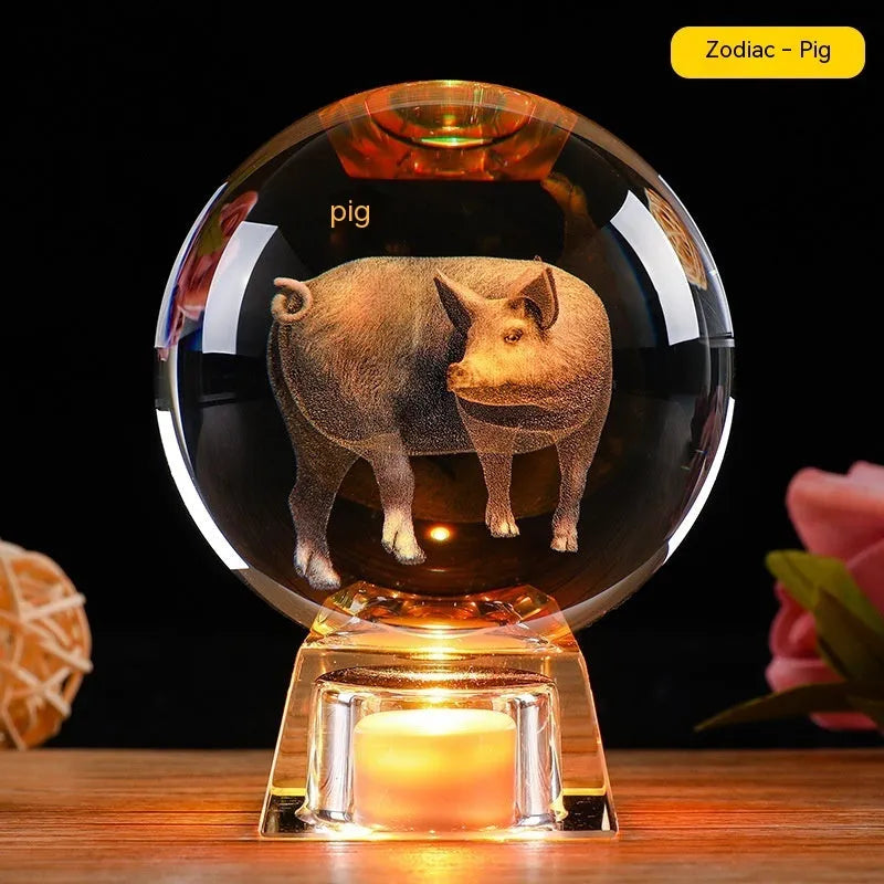 White luminous crystal ball ornament with Chinese zodiac animal figure on electronic base.