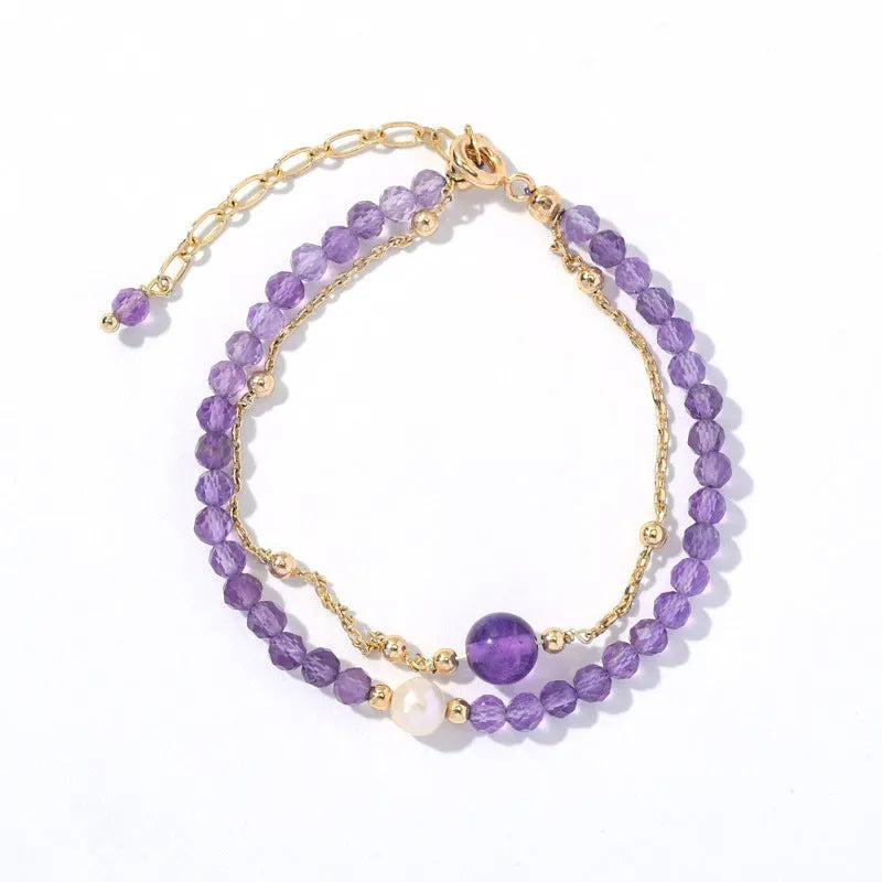 Close-up of a women's amethyst crystal bracelet with a diamond shape and Chinese style design.