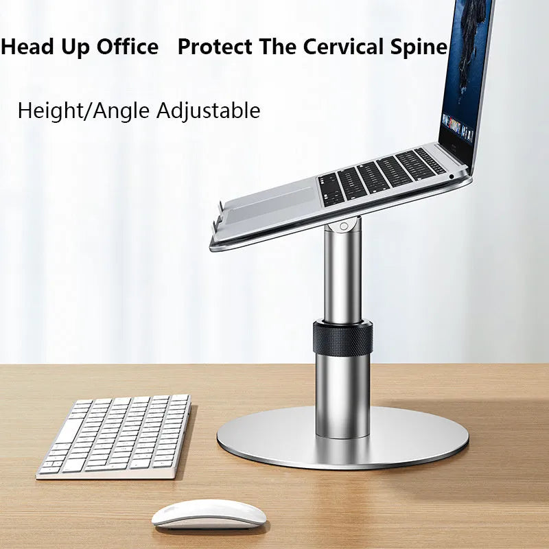 Silver adjustable aluminium laptop stand with rotating base on a desk.