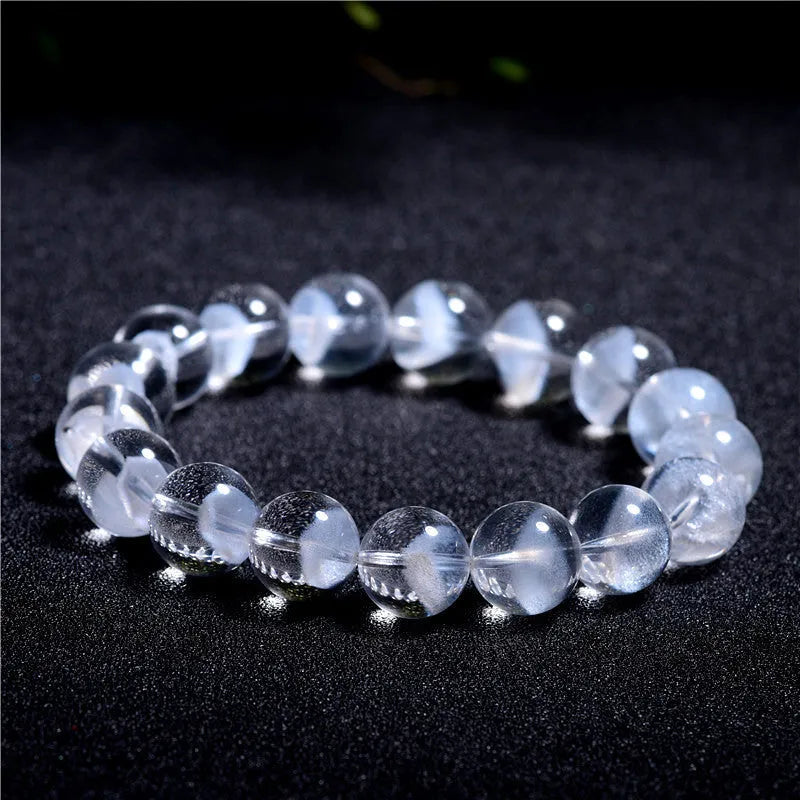 Women's white crystal pyramid bead bracelet with Ruyi element on wrist