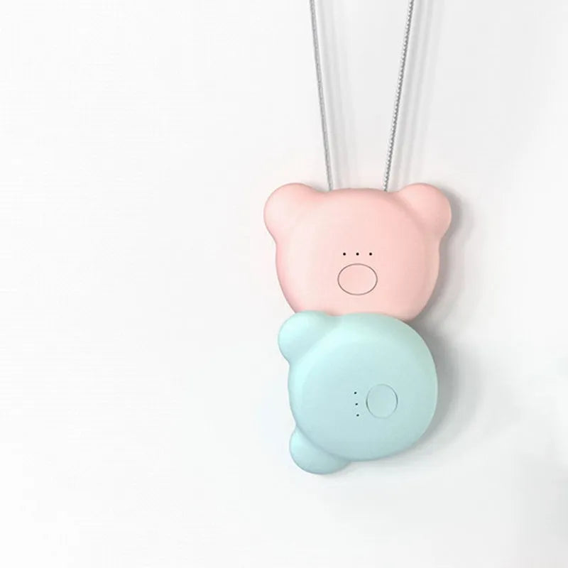 Mini USB portable air purifier necklace in blue, shown next to its charging cable.