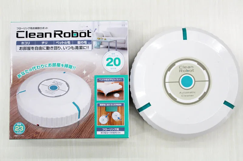Compact black and white robot vacuum cleaner on a wooden floor