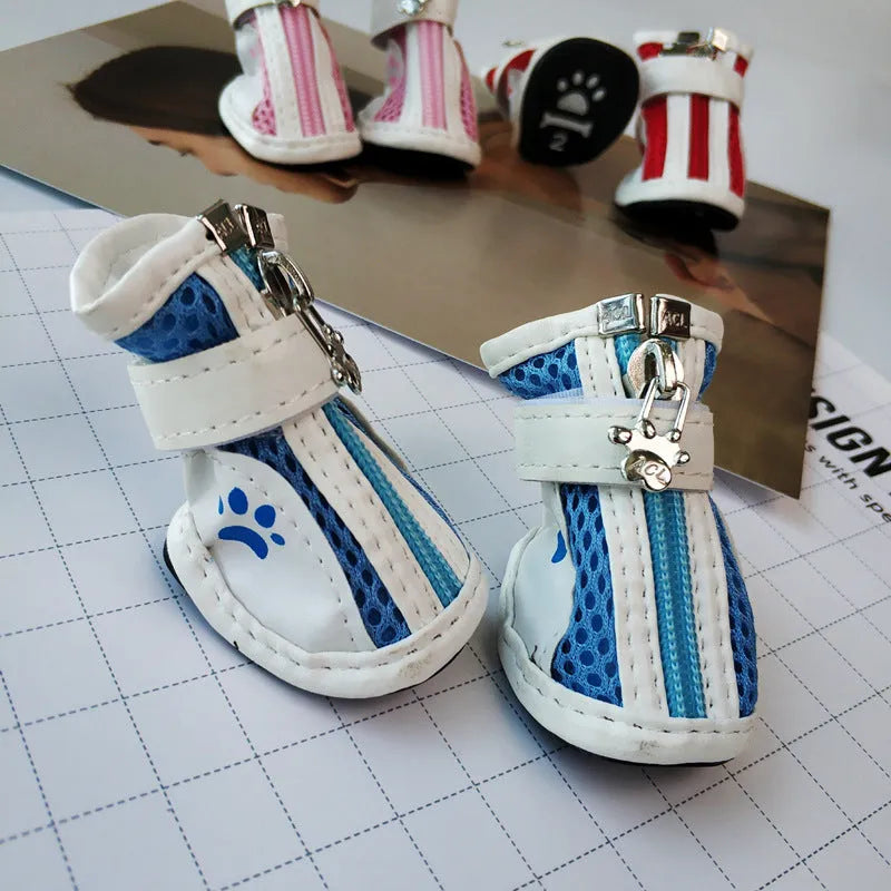 Set of four blue cloth dog shoes with zipper closures and non-slip soles for small pets.