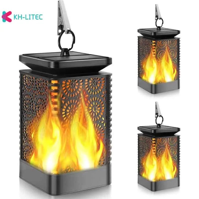 Set of four black solar-powered LED lanterns with flickering flame effect for garden paths.