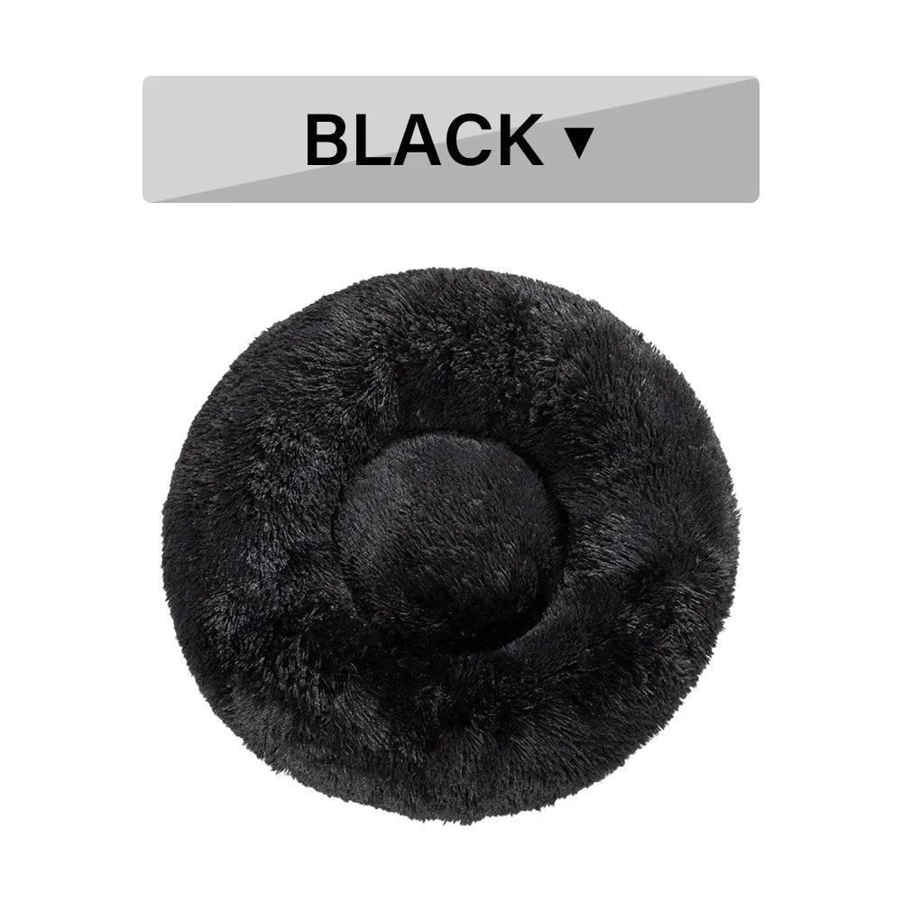 Fluffy grey donut dog bed with raised rim, shown with a small dog sleeping inside.