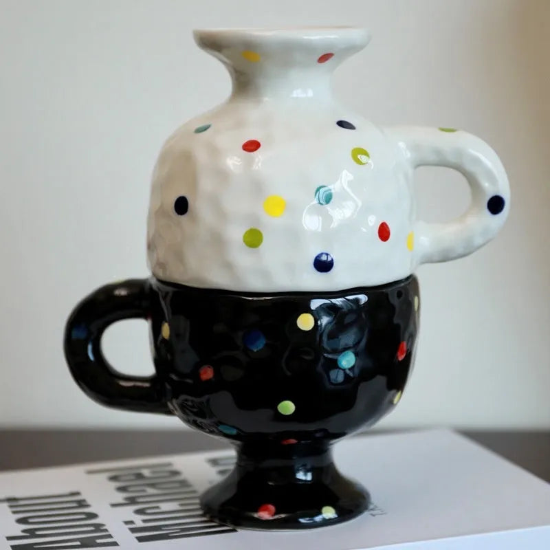 A handmade, irregularly shaped ceramic mug in a solid colour, shown on a table.