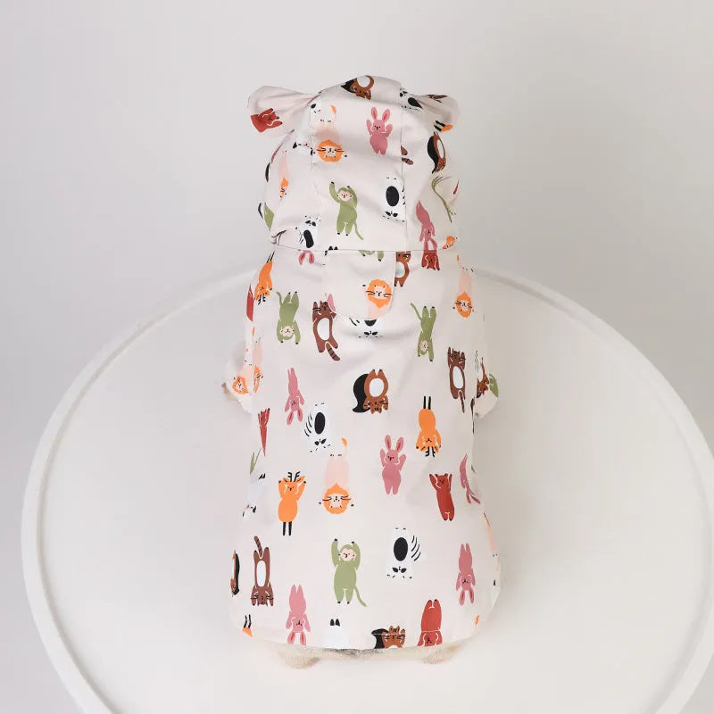 Beige dog raincoat with cartoon cat head pattern, showing waterproof PU material