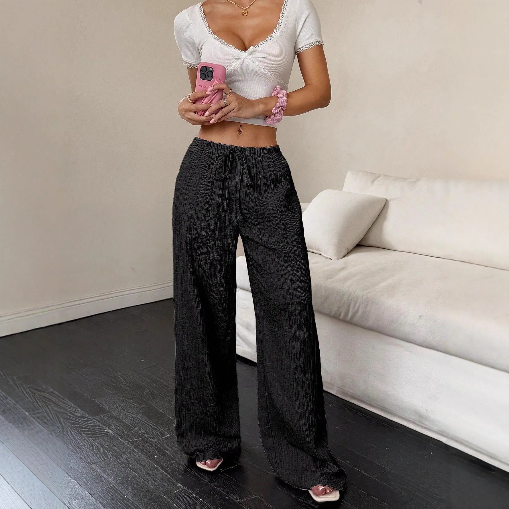 Women's wide leg casual trousers with lace-up waist detail in black and pink.