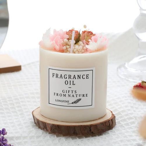 Aromatherapy candle with dried flowers embedded in wax, shown with optional wooden chip base and gift box.