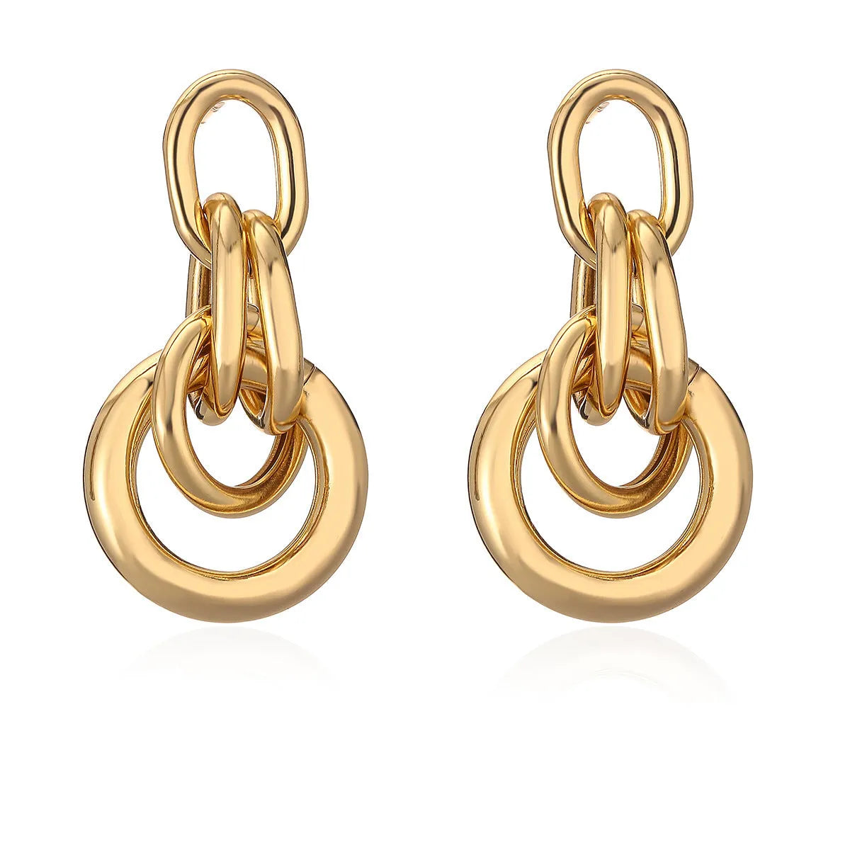 Geometric gold-coloured copper earrings with irregular design elements and high-profile construction