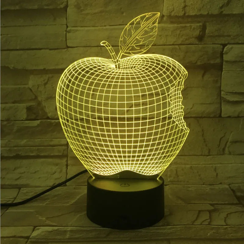Colourful 3D fruit-shaped LED night light with touch control on a surface.