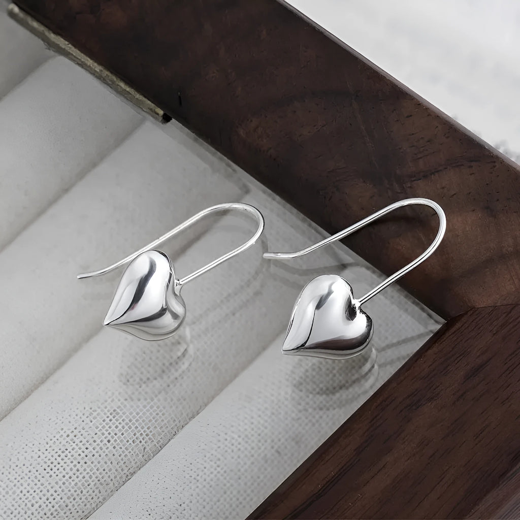 Silver-coloured heart-shaped earrings with 3D glossy design and Korean-style elements