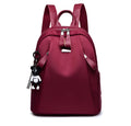 Medium capacity Oxford cloth rucksack in wine red with double straps and organised internal compartments