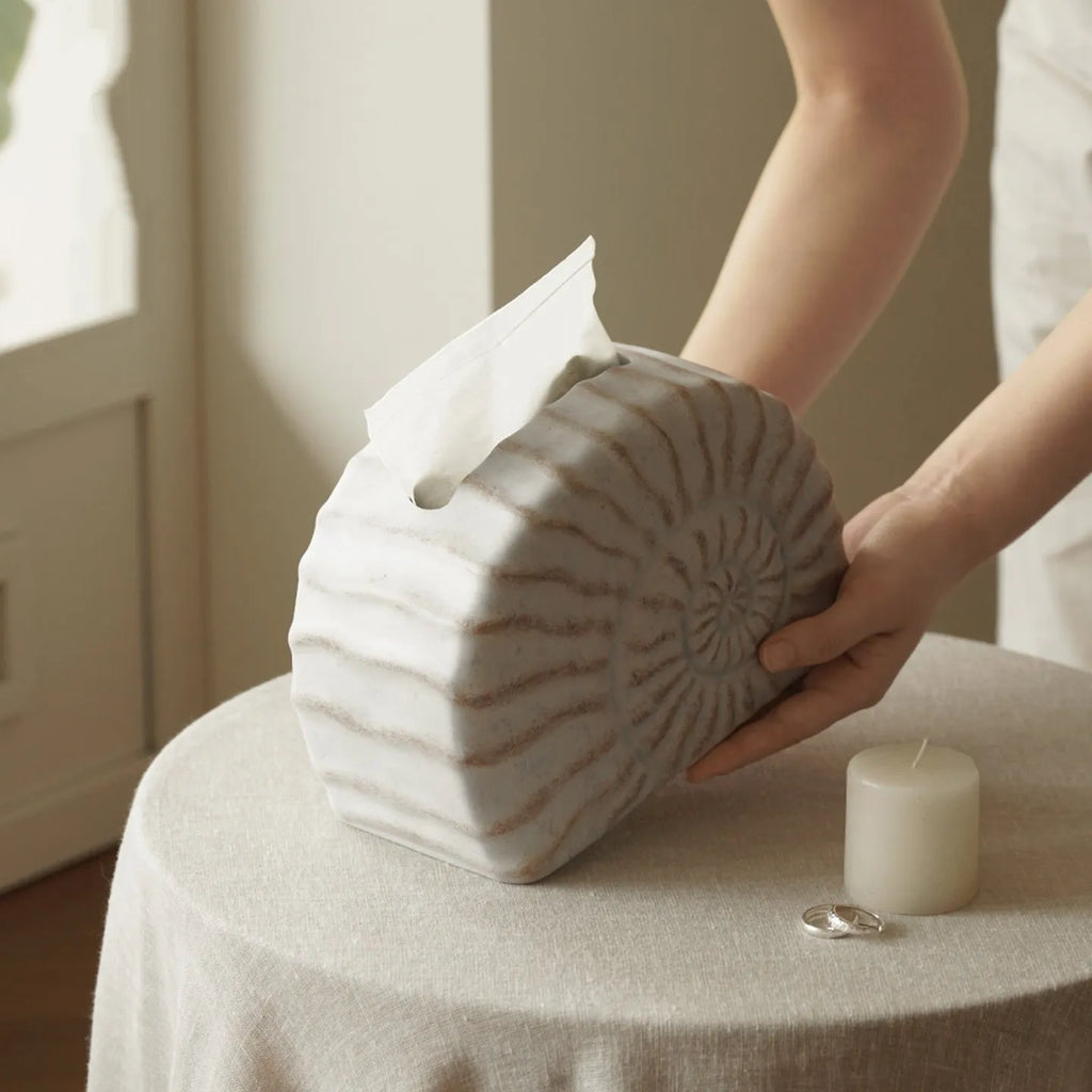 Modern simple resin tissue box cover with decorative conch ramble pattern.