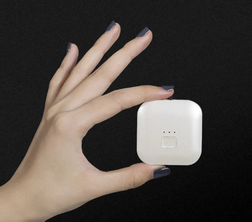 Mini USB portable air purifier necklace in blue, shown next to its charging cable.