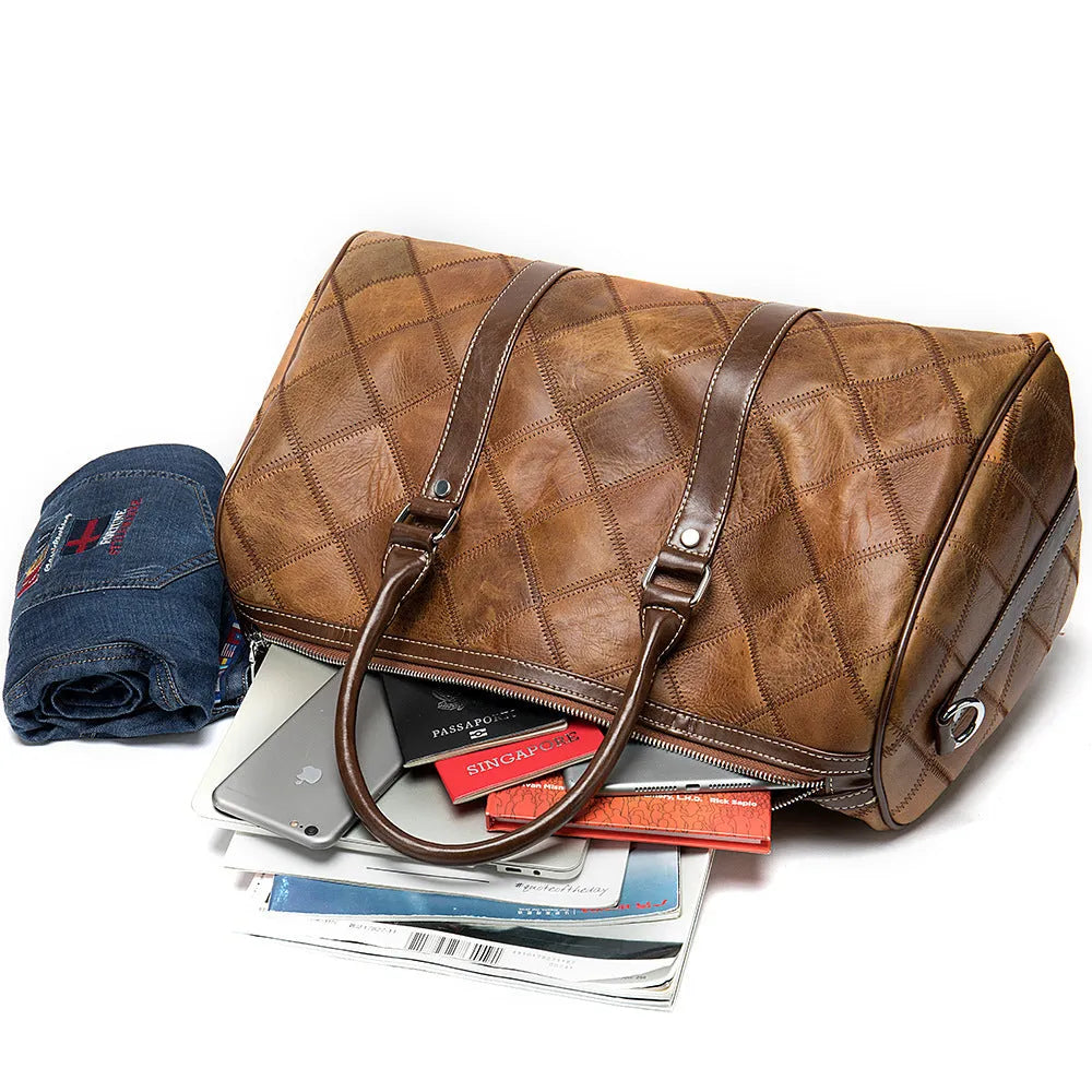 Vintage style brown leather men's duffel bag with a single shoulder strap.