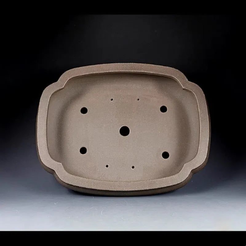 Handmade antique purple clay papaya-shaped flower pot on a tabletop
