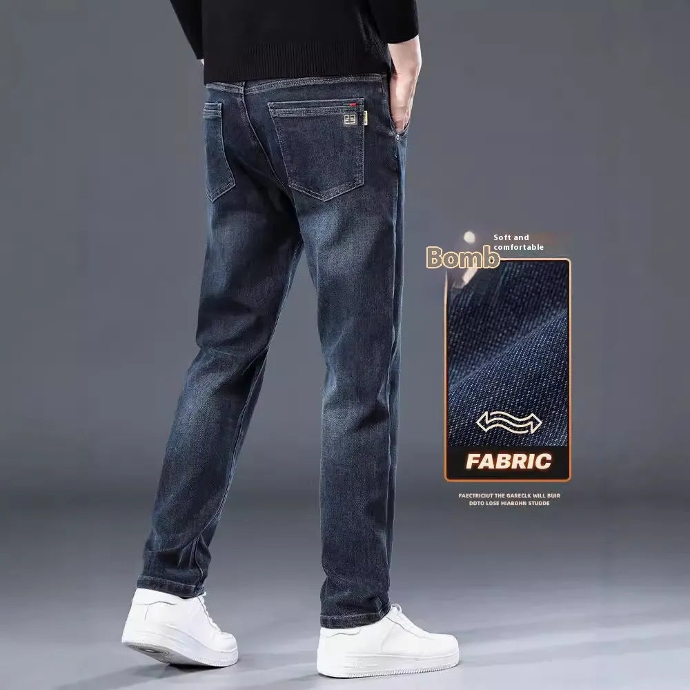 Man wearing blue grey slim straight casual trousers with a loose fit for summer street fashion.