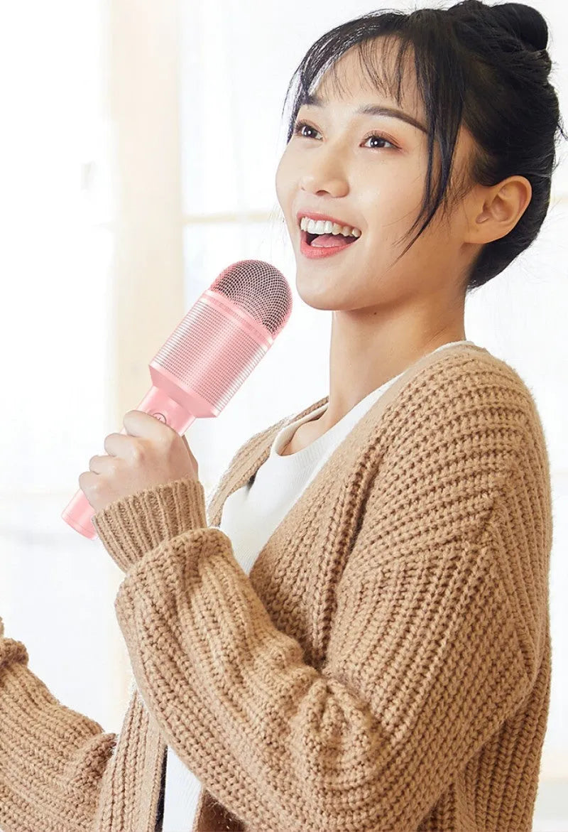 Wireless Bluetooth karaoke microphone in pink, blue, or green colour with USB port.