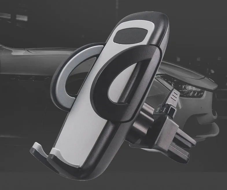Black car air vent mobile phone holder attached to air conditioning outlet holding smartphone
