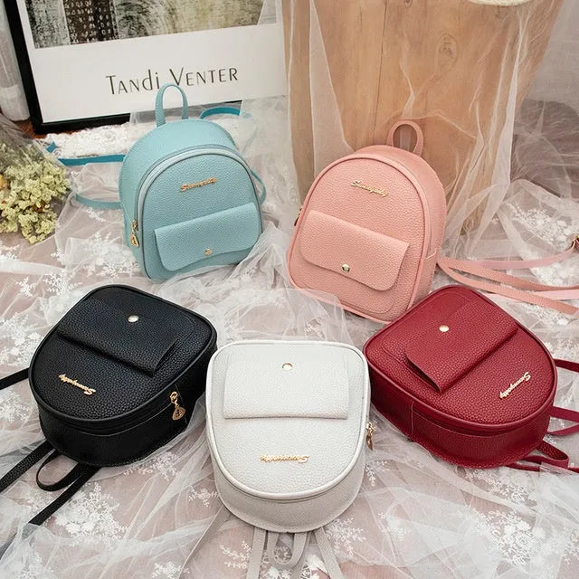 Women's small PU backpack shoulder bag in black, blue, grey, pink, or red with zipper closure