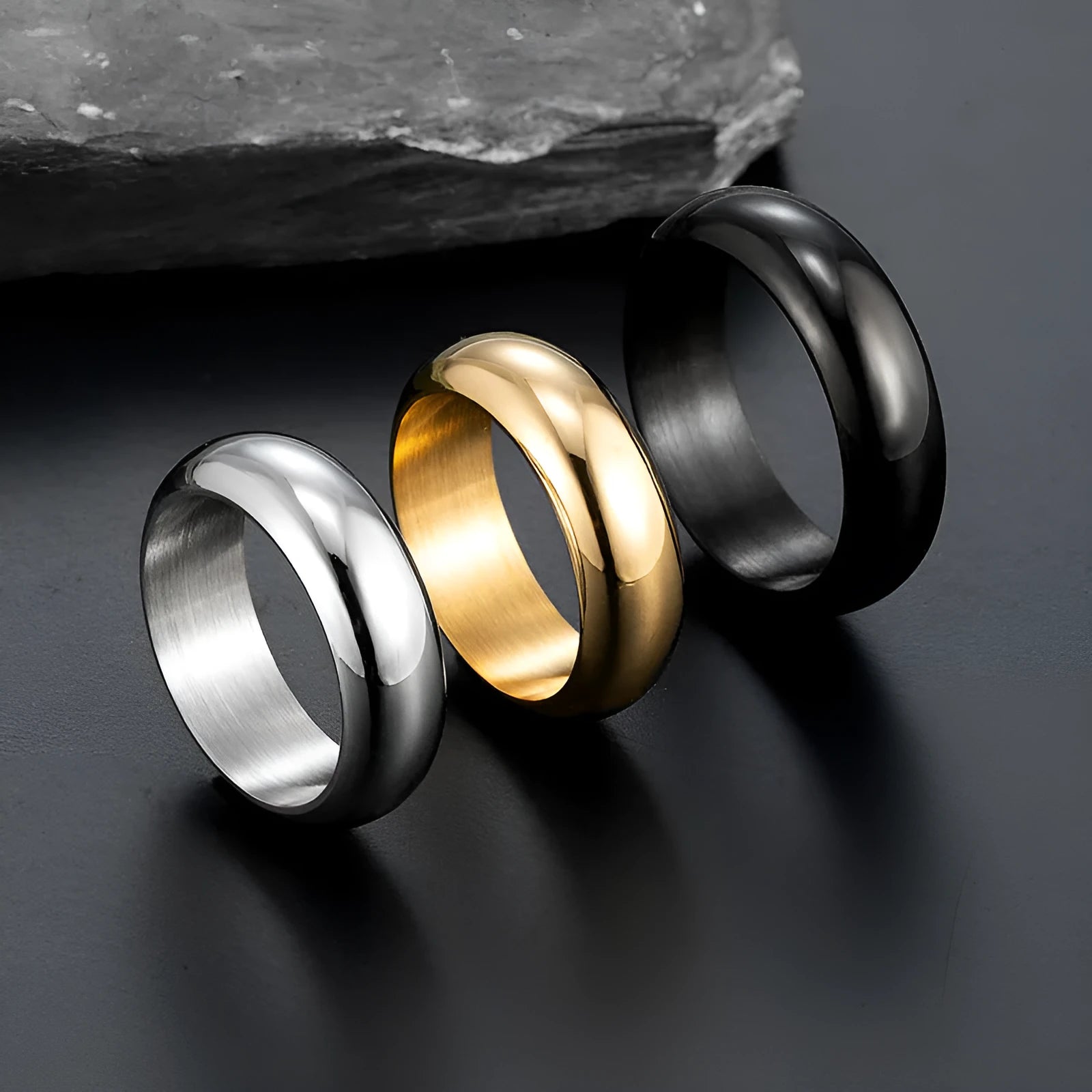 Glossy electroplated titanium steel ring shown in gold, black, and steel colour options on a plain background.