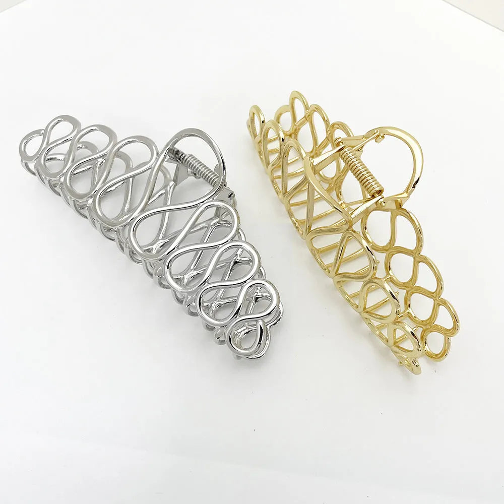 Large gold and silver alloy hair clip with a minimalist design and tassel detail for updo hairstyles.
