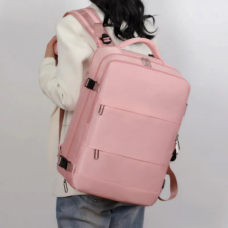 Large purple travel backpack with multiple compartments shown open to reveal organisational pockets