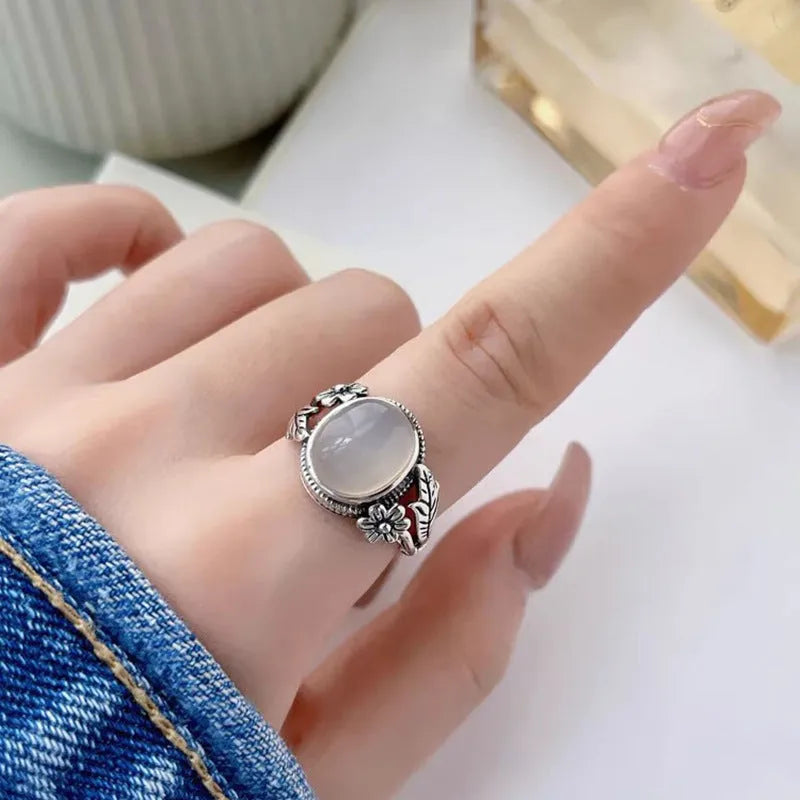 Adjustable copper U-shaped vintage ring with a white chalcedony effect finish.