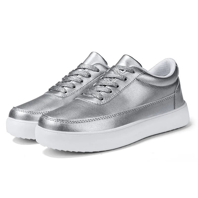 Women's white leather lace-up flat casual shoes on a plain background.
