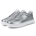 Women's white leather lace-up flat casual shoes on a plain background.