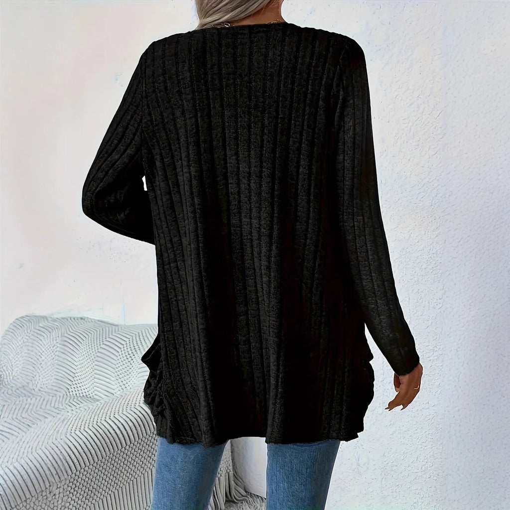 A woman's loose-fit long sleeve cardigan in Grandad Grey with pockets, shown on a hanger.