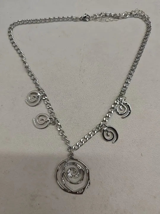 Spiral donut jewellery set showing necklace, bracelet and ear hooks in gold finish with geometric circle design