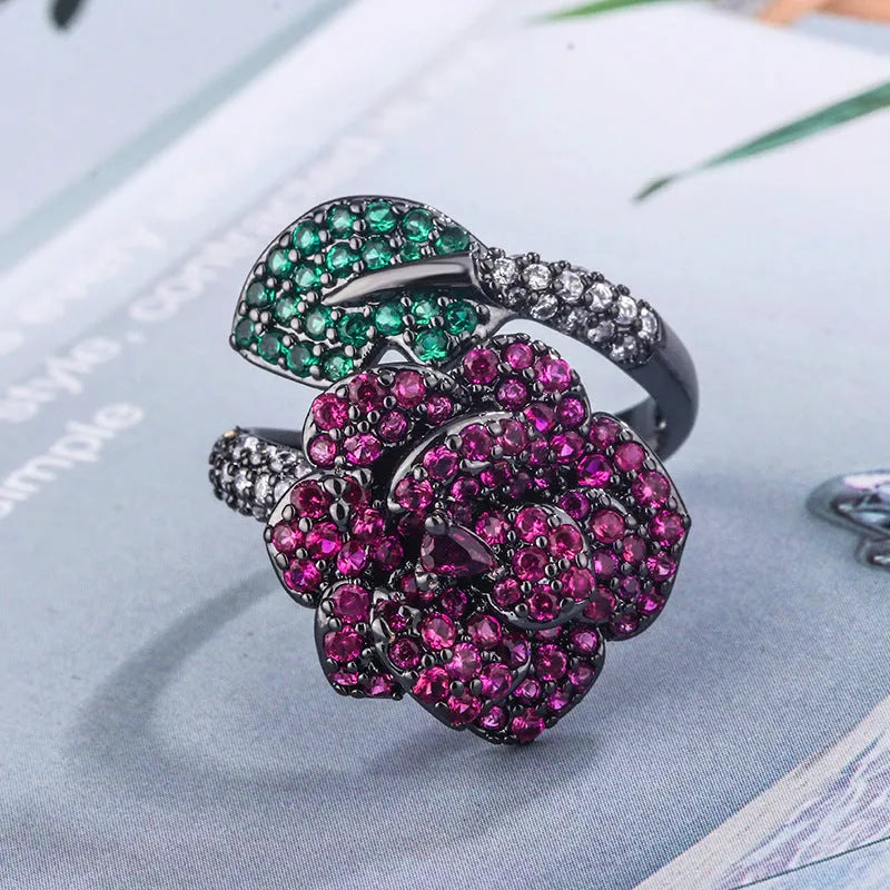Women's black gold geometric ring with gold-plated red corundum flower detail